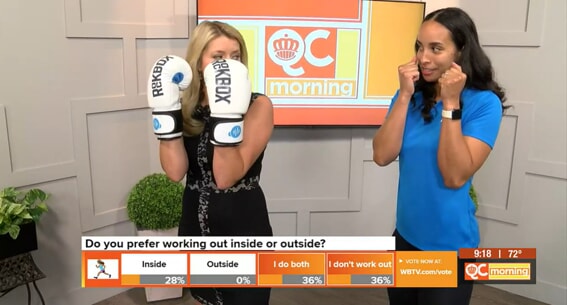 Anchor poses with RockBox gloves with an instructor